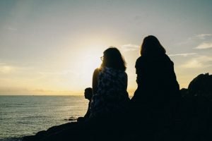 silhouette-of-two-women-facing-body-of-water-1477495-1.jpg
